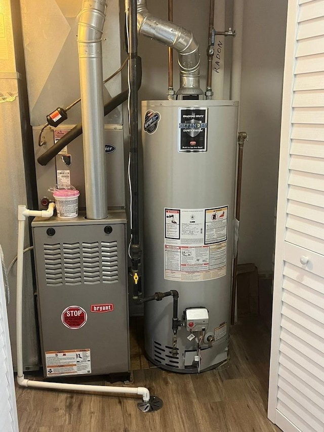 utility room with heating unit and water heater