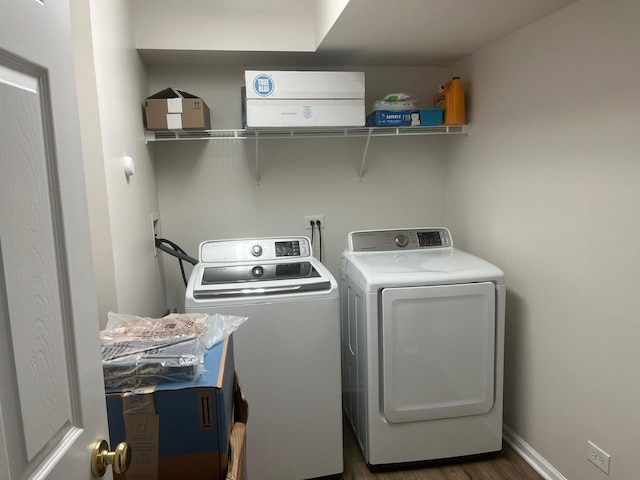 laundry area with separate washer and dryer and dark hardwood / wood-style flooring