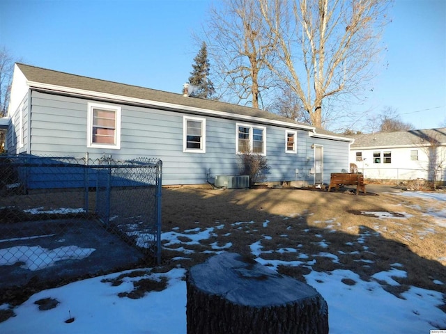 snow covered house featuring cooling unit