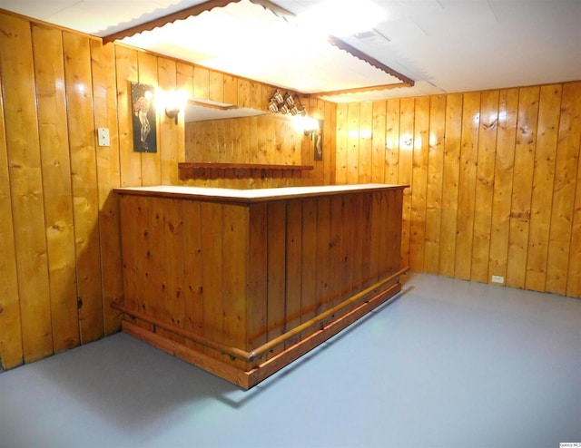 bar with concrete floors and wood walls