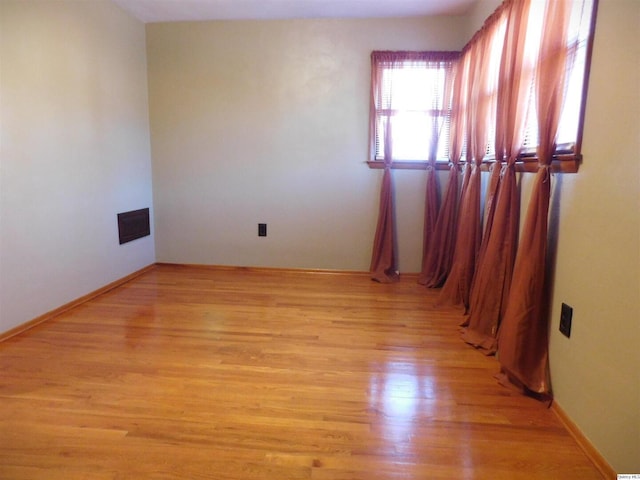 spare room featuring light hardwood / wood-style floors