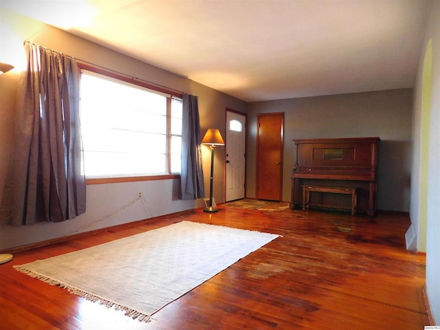 unfurnished living room featuring dark wood-type flooring