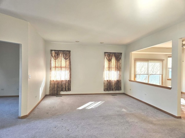 unfurnished room with light colored carpet