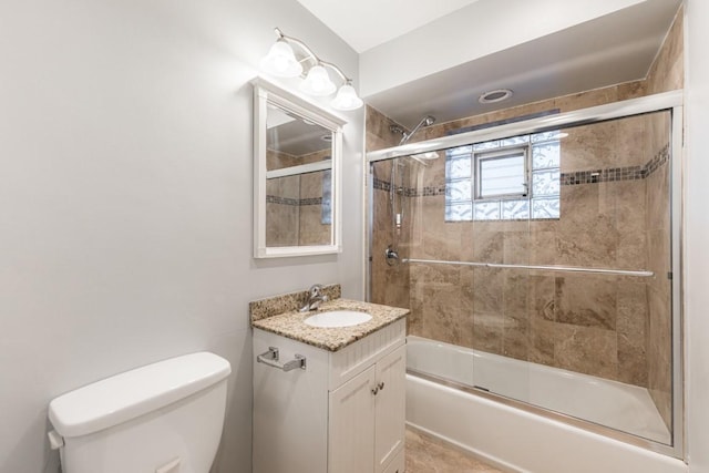 full bathroom with toilet, bath / shower combo with glass door, and vanity