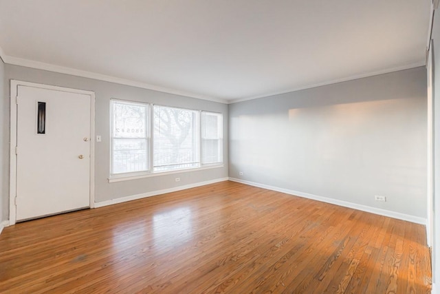 empty room featuring crown molding and hardwood / wood-style floors