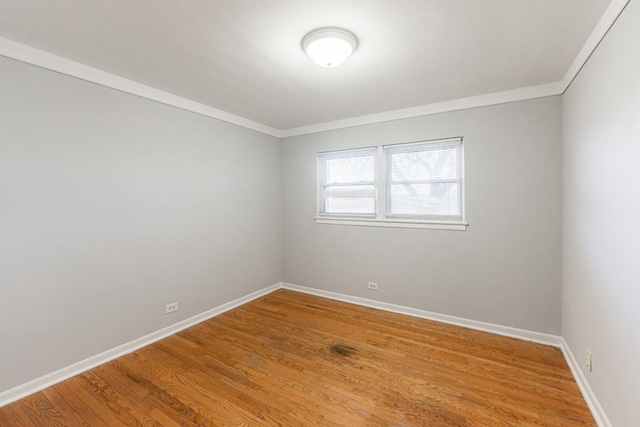 spare room featuring ornamental molding and hardwood / wood-style floors