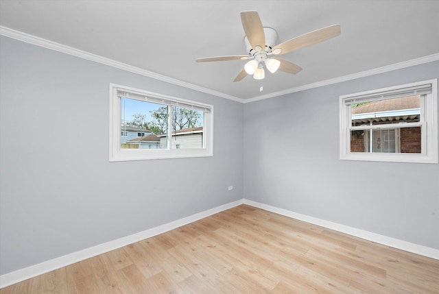 empty room with baseboards, wood finished floors, a ceiling fan, and ornamental molding