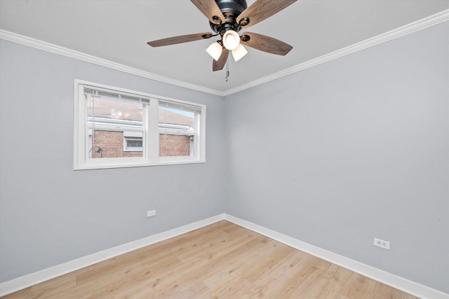 spare room featuring crown molding, ceiling fan, light wood-style floors, and baseboards