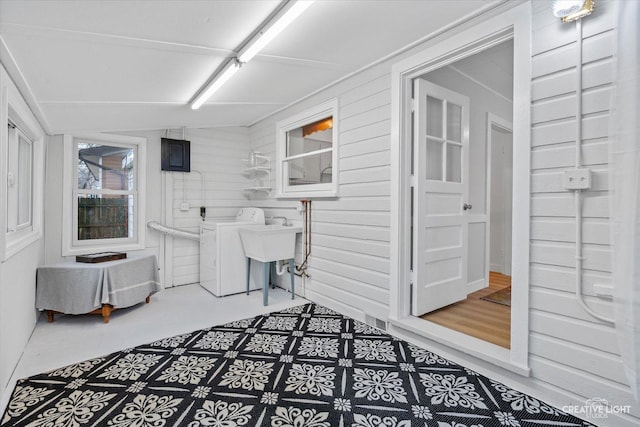 laundry room featuring washer / clothes dryer and wood walls