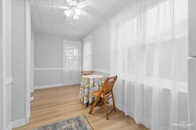 dining area with wood-type flooring and ceiling fan