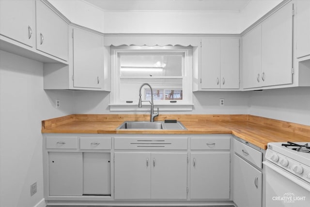 kitchen featuring white cabinetry, white gas stove, and sink