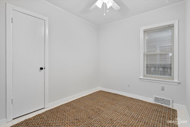 spare room with light tile patterned floors, crown molding, and ceiling fan