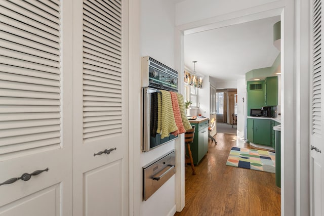 442 Wolfe Dr, Loda, IL 60948 - hallway featuring dark wood finished floors and a chandelier