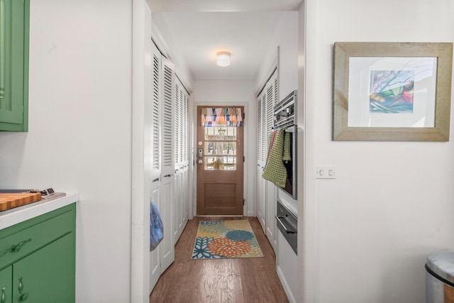 doorway to outside with wood-type flooring