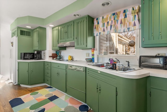 kitchen with green cabinetry, sink, light hardwood / wood-style floors, and black appliances