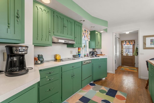 kitchen with sink, dark hardwood / wood-style floors, green cabinets, and black appliances