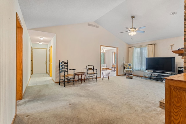 carpeted living room featuring ceiling fan and lofted ceiling