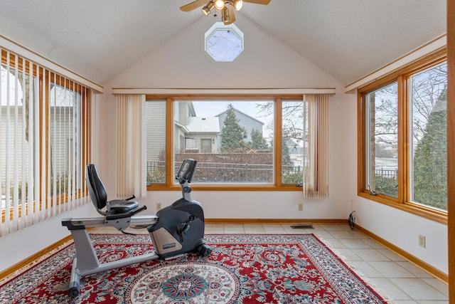 exercise room featuring light tile patterned floors, baseboards, visible vents, and vaulted ceiling