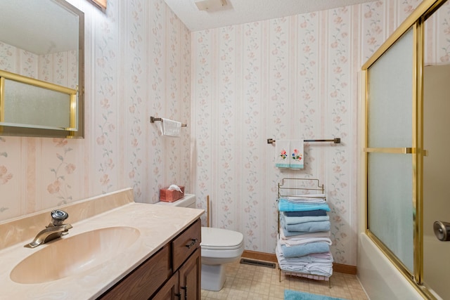 bathroom with a textured ceiling, toilet, vanity, visible vents, and wallpapered walls