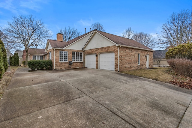 view of front of property featuring a garage, concrete driveway, brick siding, and a chimney