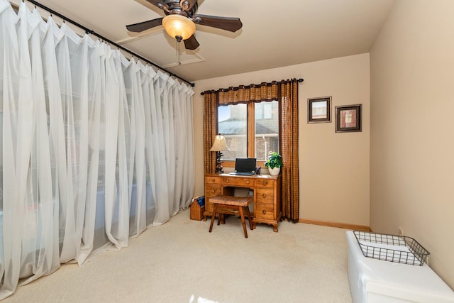 home office with ceiling fan and carpet