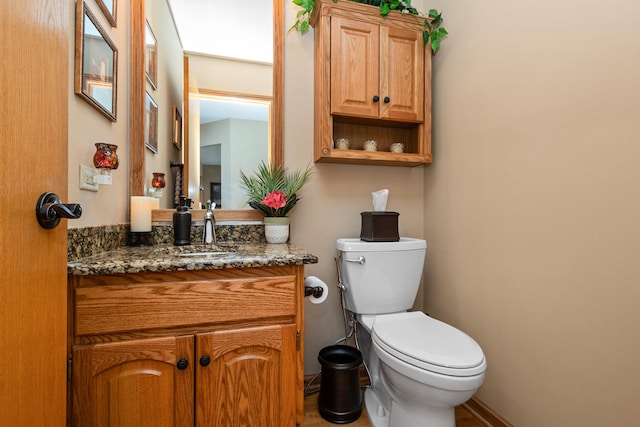 bathroom featuring toilet and vanity