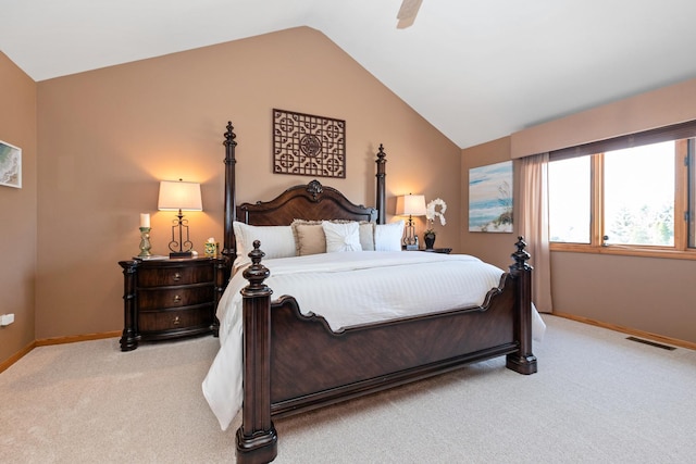 bedroom featuring light colored carpet, vaulted ceiling, and ceiling fan