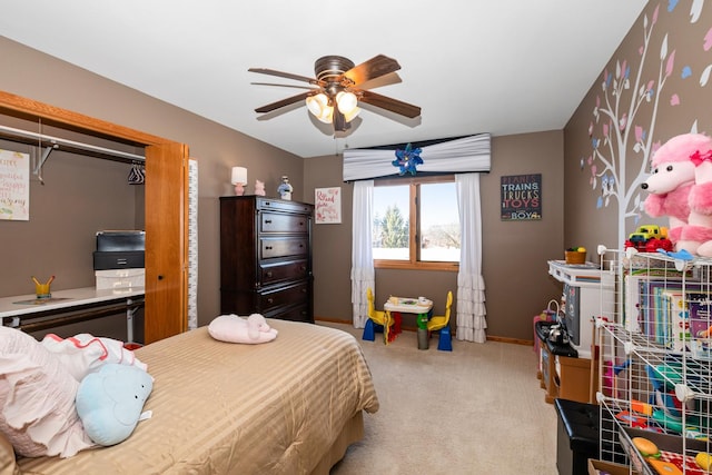 bedroom featuring light colored carpet, a closet, and ceiling fan