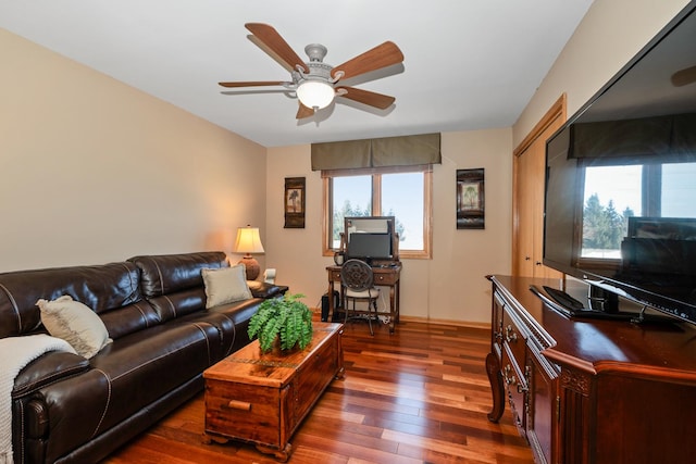 living room featuring ceiling fan, dark hardwood / wood-style floors, and a wealth of natural light