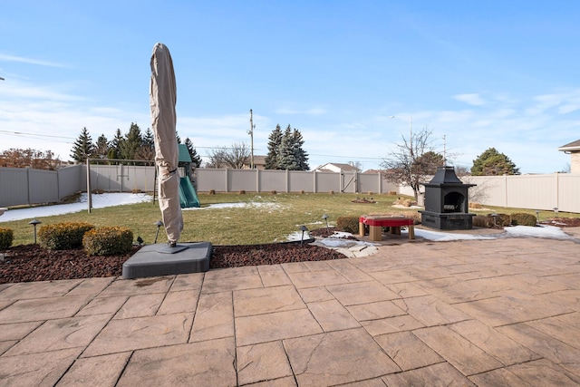 view of patio / terrace with a playground and exterior fireplace