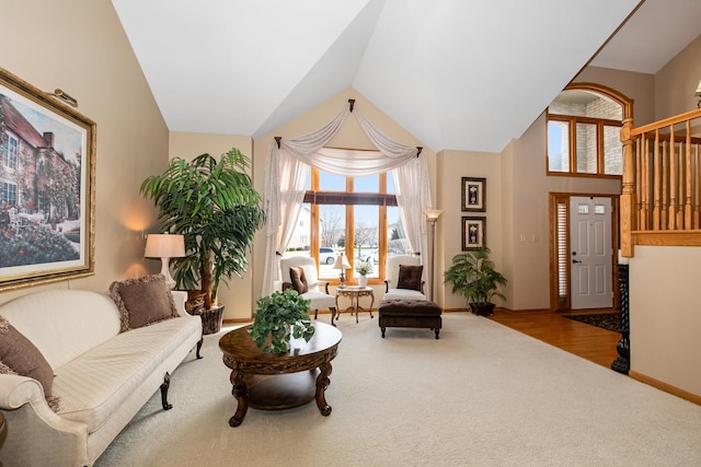 living area with light colored carpet and lofted ceiling