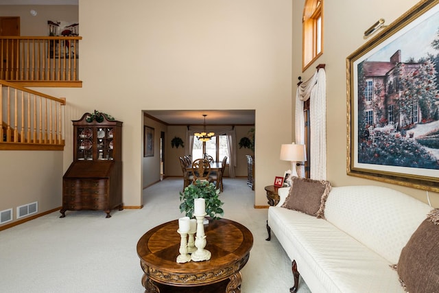 carpeted living room with a chandelier and a towering ceiling