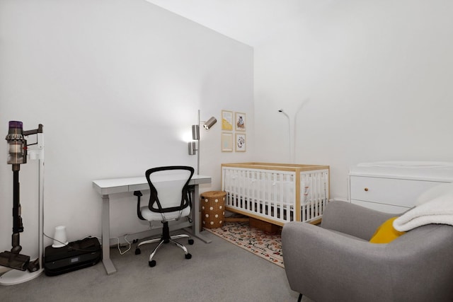 bedroom featuring carpet flooring and a nursery area