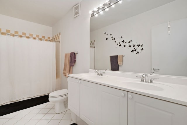 bathroom featuring tile patterned floors, vanity, and toilet