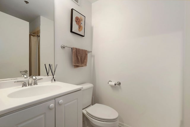 bathroom with toilet and vanity