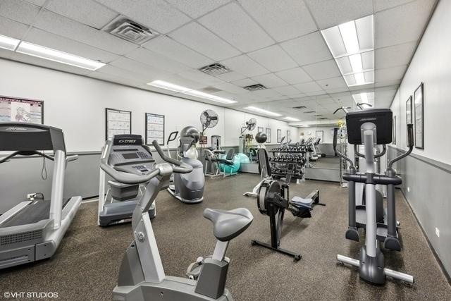 gym with a paneled ceiling