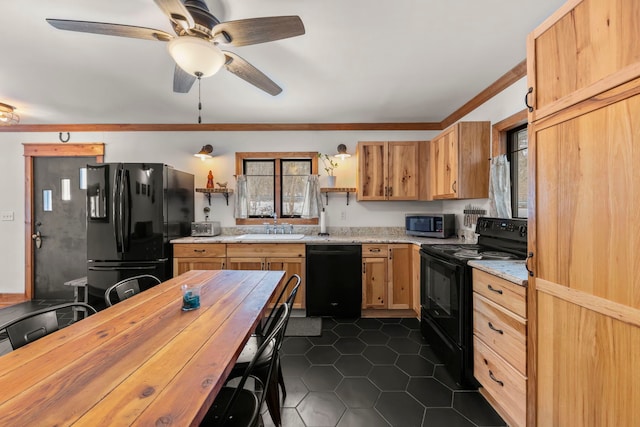 kitchen featuring sink, ornamental molding, dark tile patterned flooring, ceiling fan, and black appliances