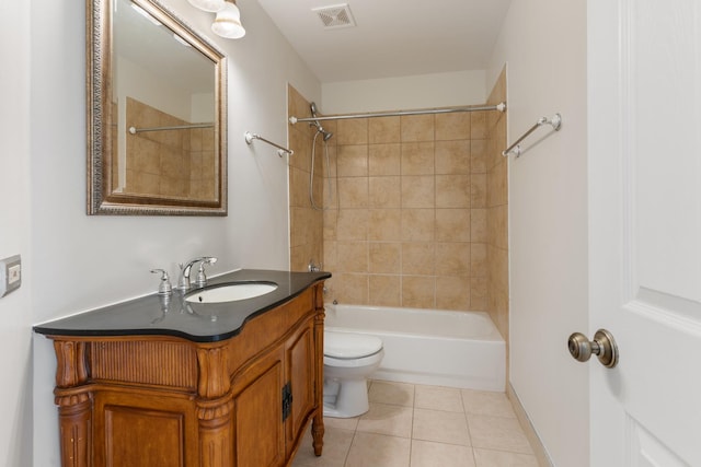 full bathroom featuring tiled shower / bath, tile patterned floors, toilet, and vanity