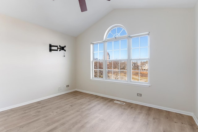 spare room with lofted ceiling, ceiling fan, and light hardwood / wood-style flooring