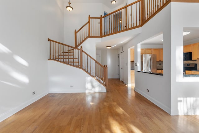 foyer with light hardwood / wood-style floors and a high ceiling