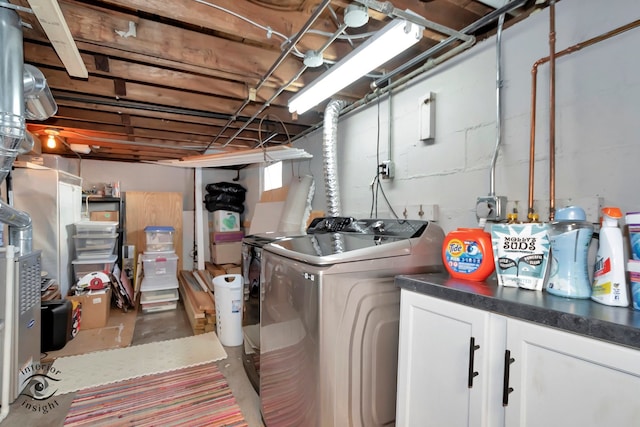 laundry room with washing machine and dryer and cabinets