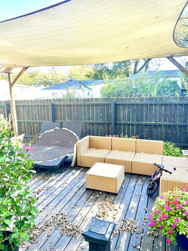 wooden terrace with an outdoor living space