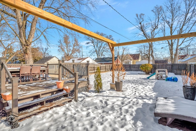 snow covered patio featuring a wooden deck