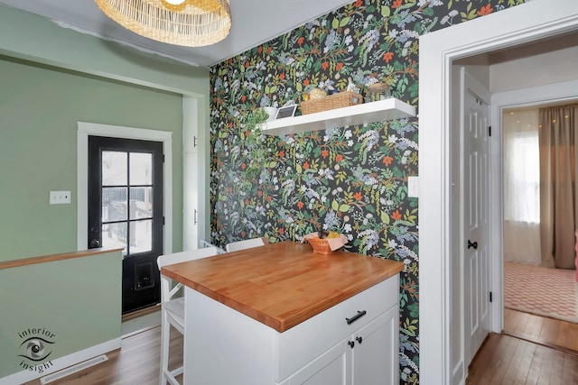 interior space with a wealth of natural light and hardwood / wood-style floors