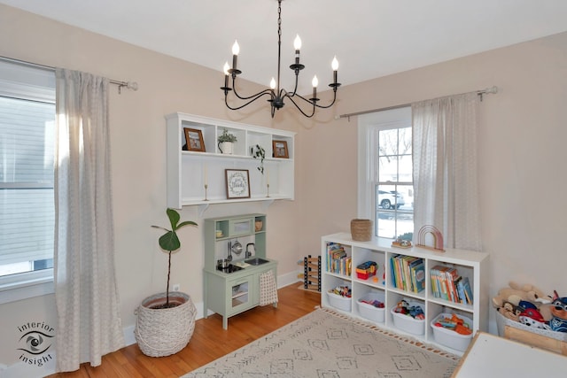 game room with light hardwood / wood-style floors