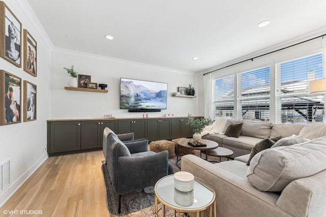 living room featuring light wood-type flooring and ornamental molding