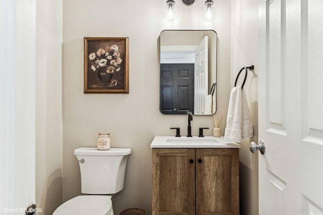 bathroom with toilet and vanity