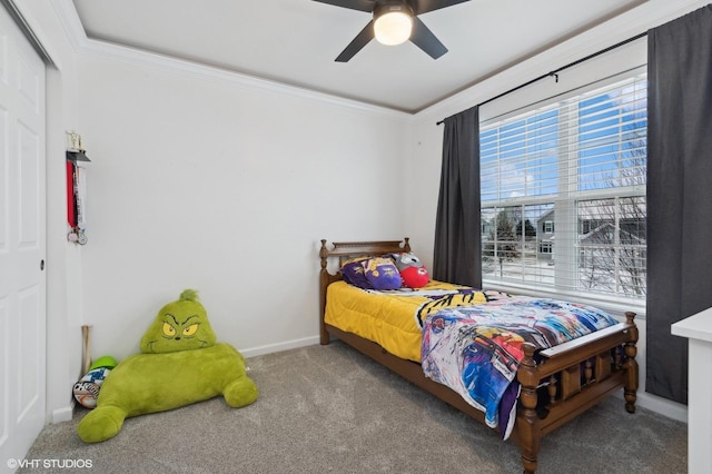 bedroom with a closet, ceiling fan, carpet flooring, and ornamental molding