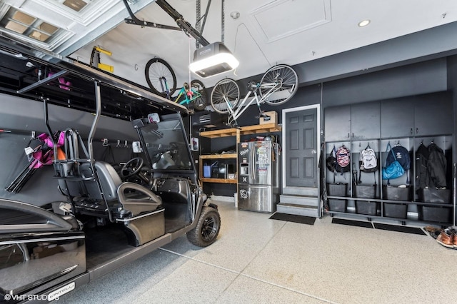 garage with stainless steel fridge with ice dispenser