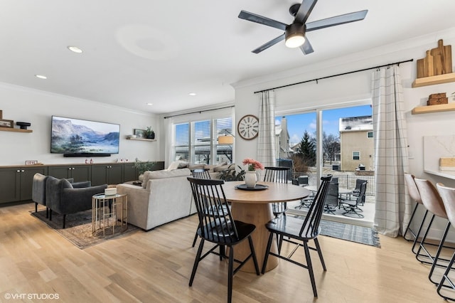 dining space featuring crown molding, light hardwood / wood-style flooring, and ceiling fan